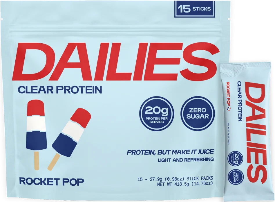 Dailies Rocket Pop Clear Protein 15-stick pouch with one blue stick and red-white-blue popsicle artwork; 20 g protein per serving and zero sugar. #flavor_rocket-pop test
